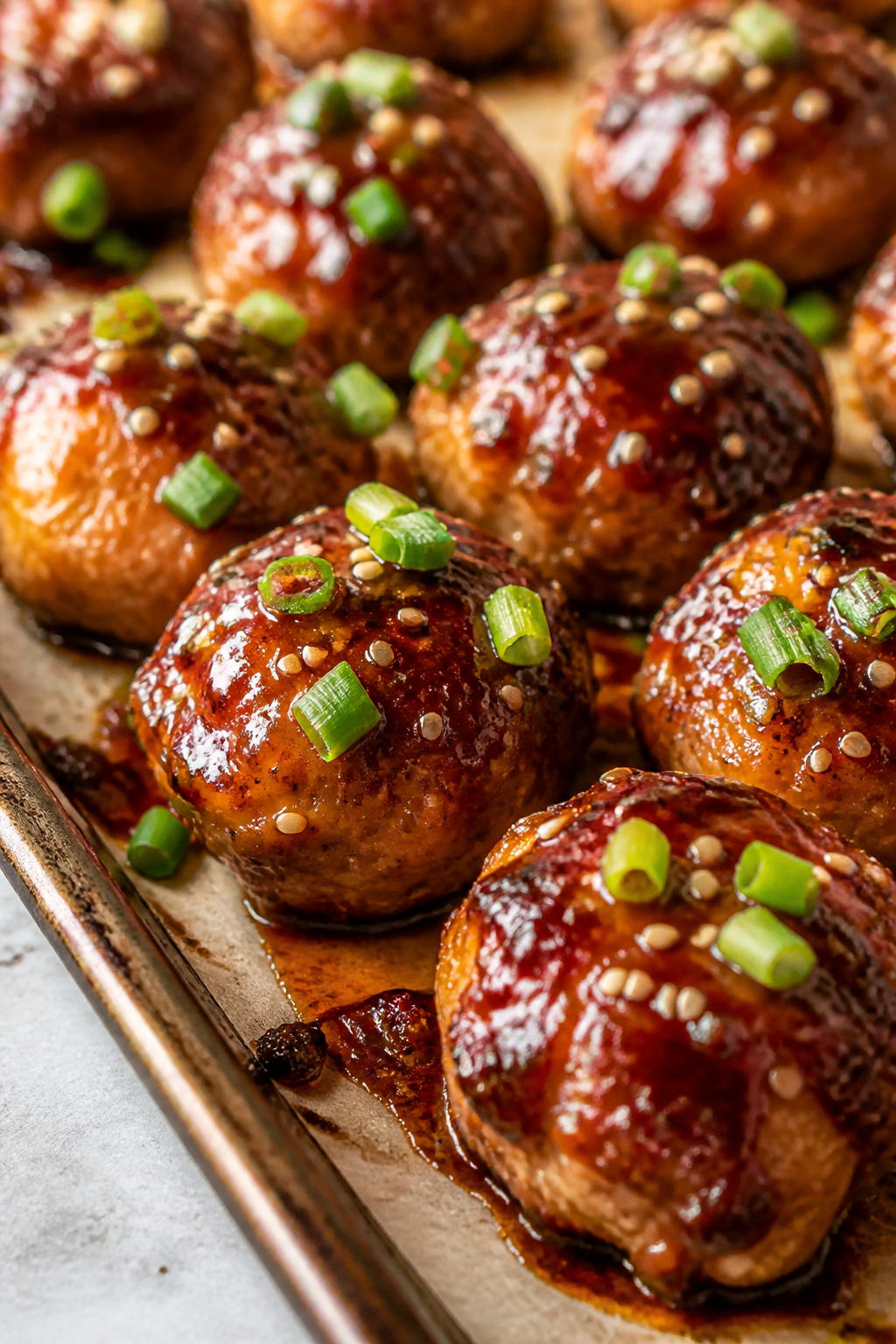 Close-up detail: Glossy BBQ-glazed turkey meatballs fresh from the oven, brushed during the last min