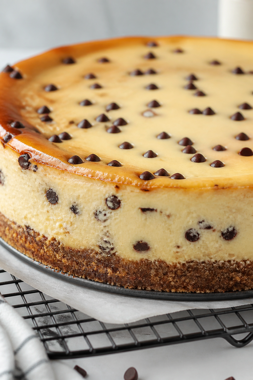 Close-up detail shot of the baked high-protein chocolate chip cheesecake just out of the springform 