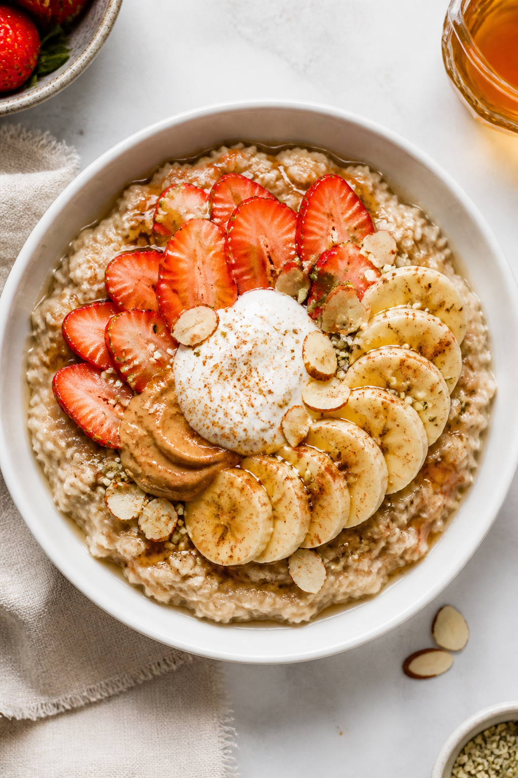 Final dish presentation: Restaurant-quality plated strawberry banana protein oatmeal in a matte whit