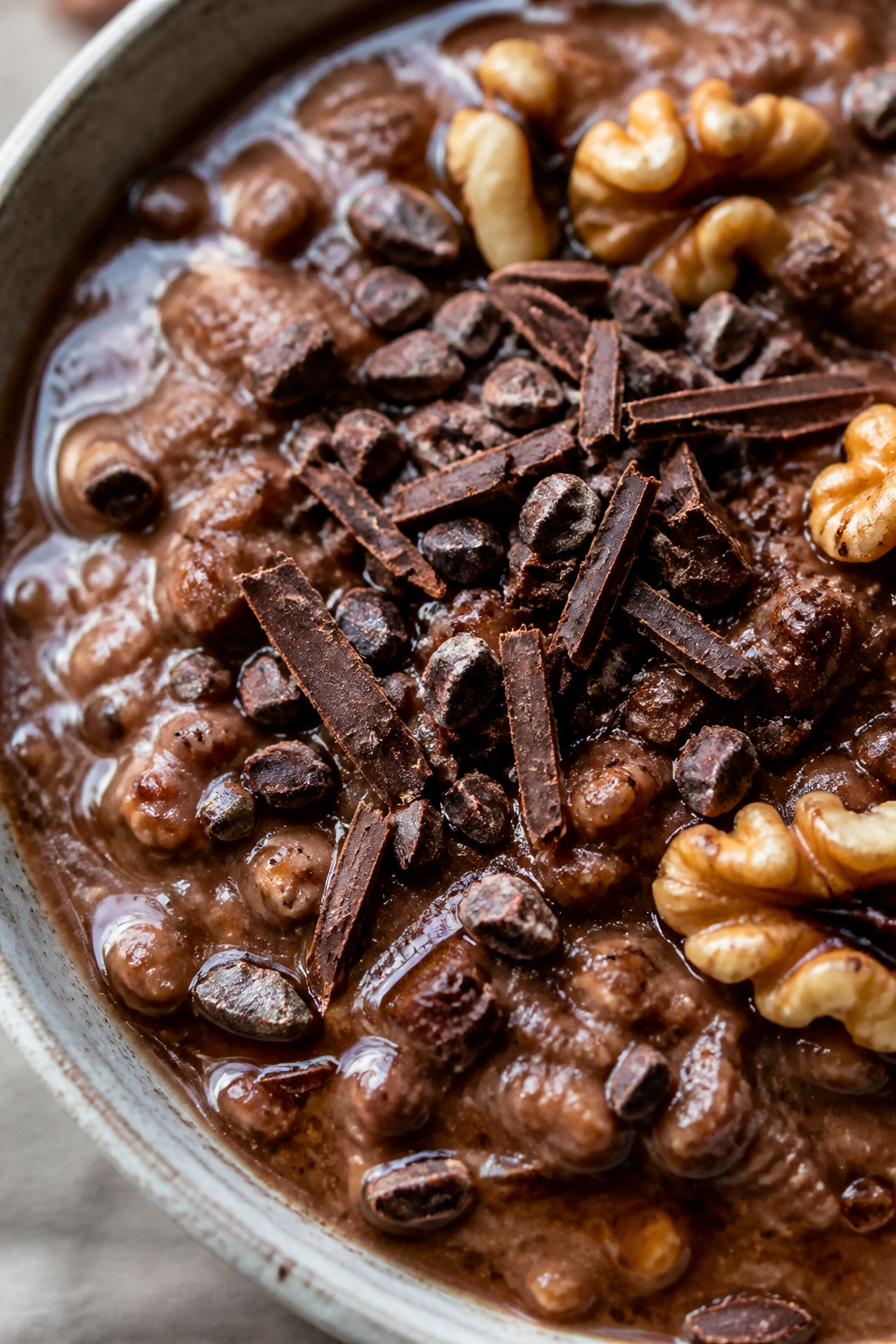 Final plated detail: Ultra-close macro of the finished mocha variation—silky coffee-cocoa oatmeal 