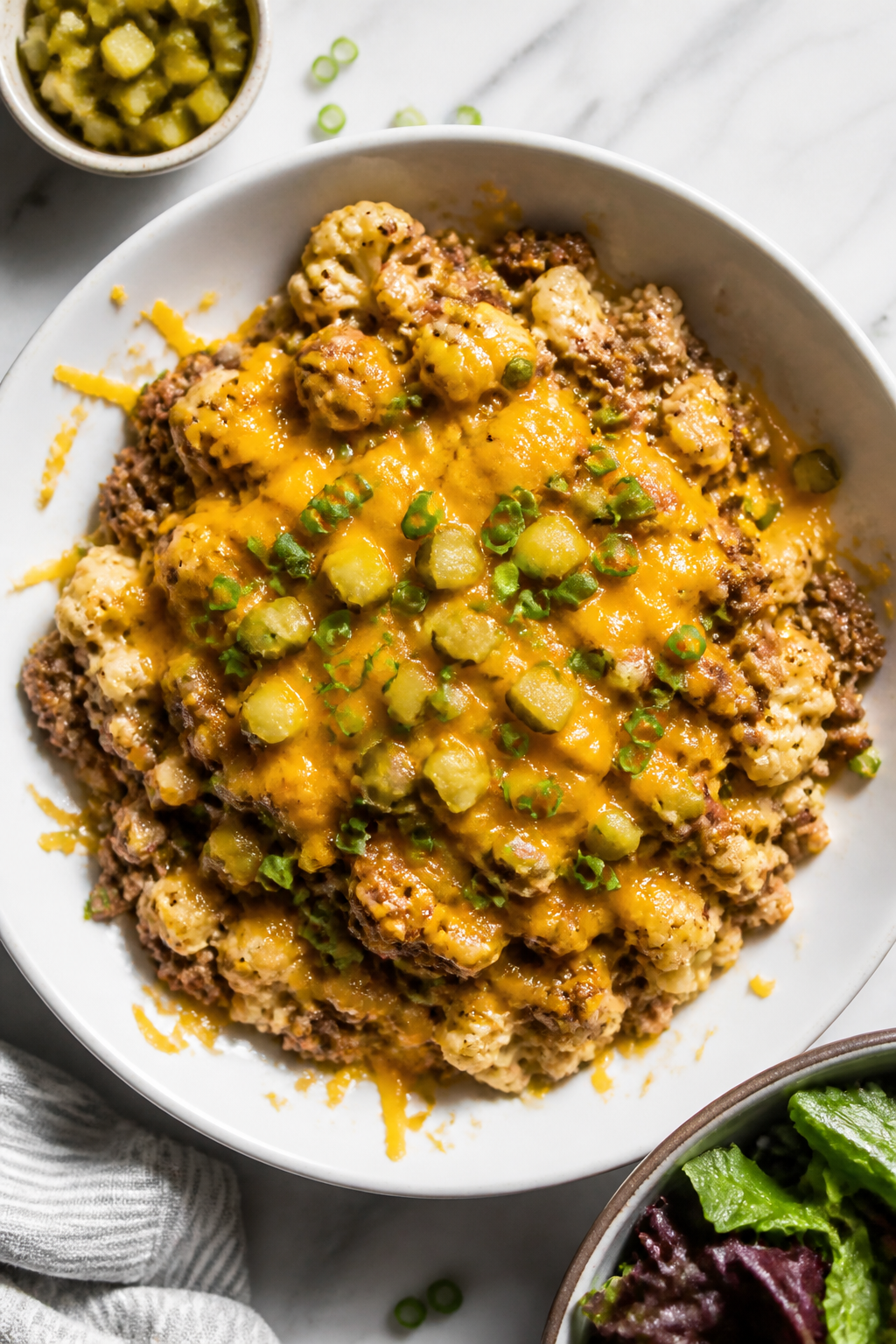 Final plated overhead: Tasty of the High Protein Cheeseburger Skillet served in a wide, shallow whit