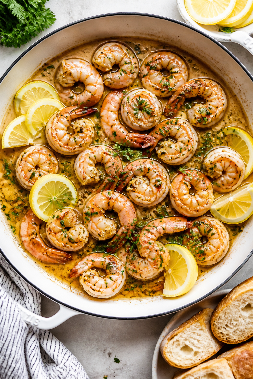Tasty top view: Overhead shot of lemon garlic shrimp served family-style in a shallow enamel skillet