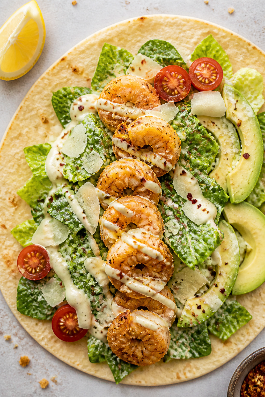 Tasty top view: Overhead shot of open-faced Crispy Shrimp Protein Caesar Wrap on a warm high-protein