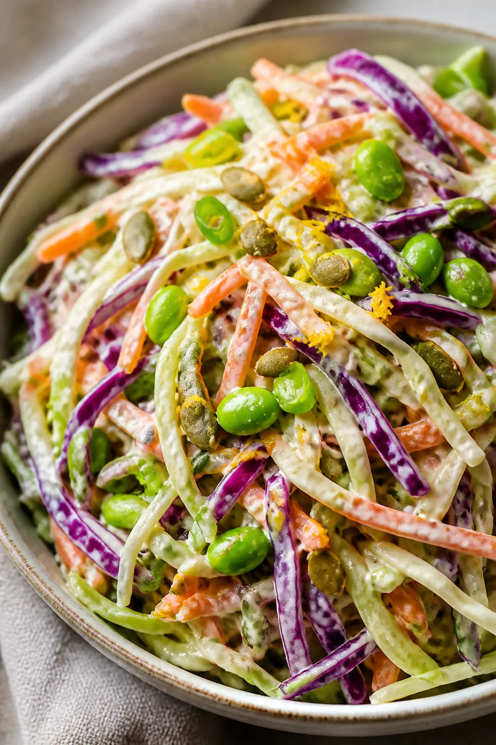 Close-up detail: A glossy tangle of prepared high-protein cabbage slaw just after tossingâthin rib