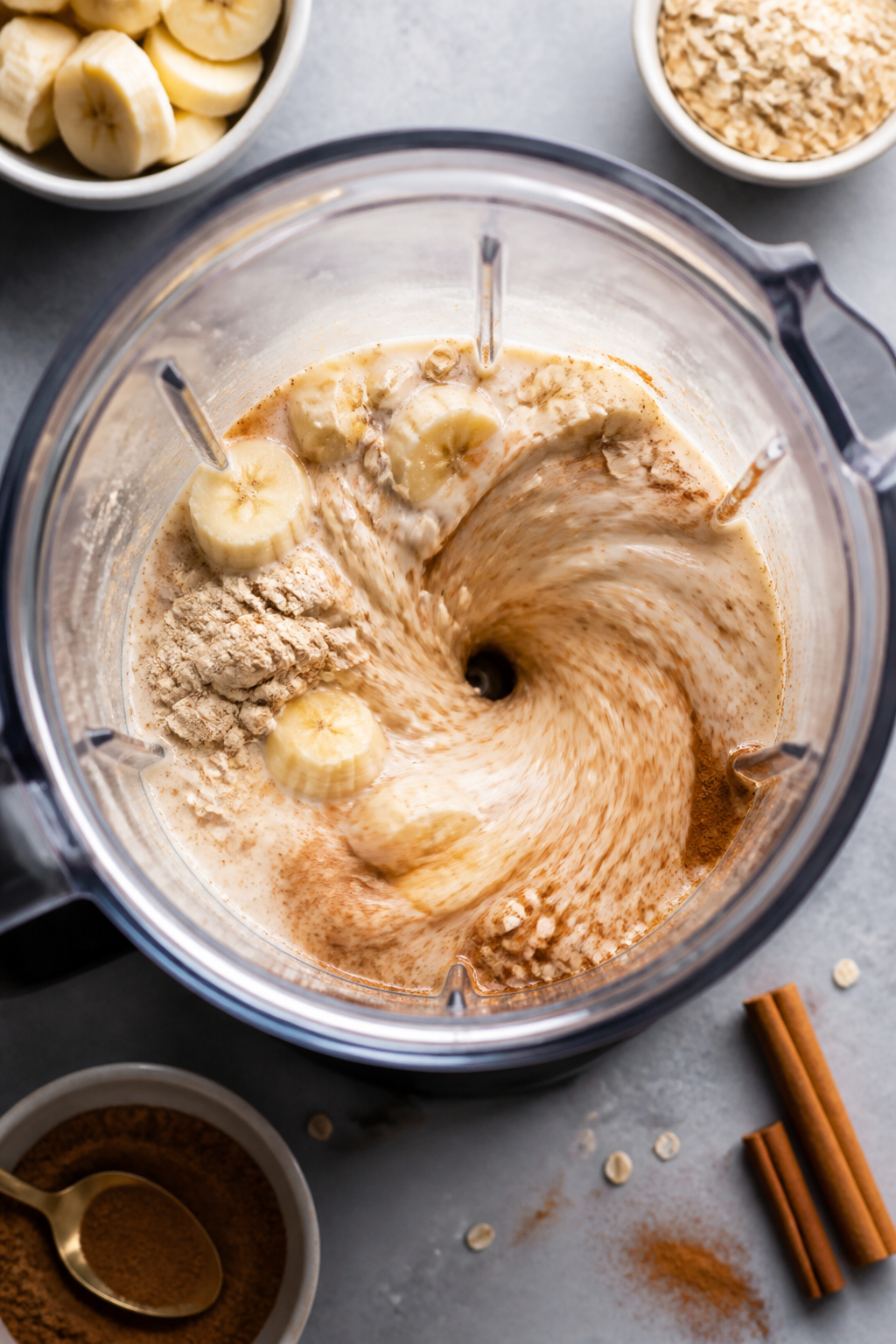 Cooking process: Action shot of the smoothie blending phase from above with the blender jar open: mi