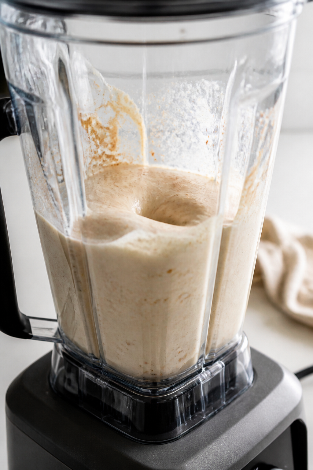 Cooking process: Blender scene mid-prep showing the liquids-first technique—milk and Greek yogurt 