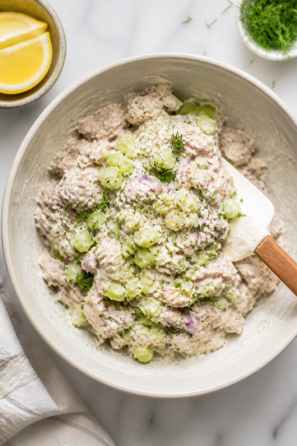 Cooking process — Greek Yogurt Tuna Salad being gently folded together: overhead shot of a medium 