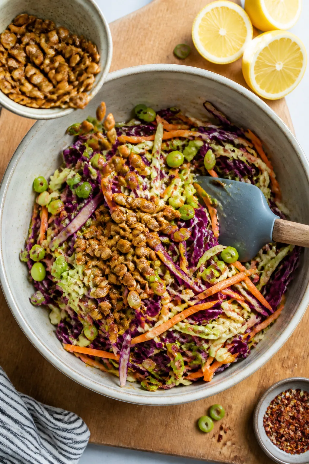 Cooking process: Overhead shot of the slaw being combinedâlarge mixing bowl filled with dressed ca