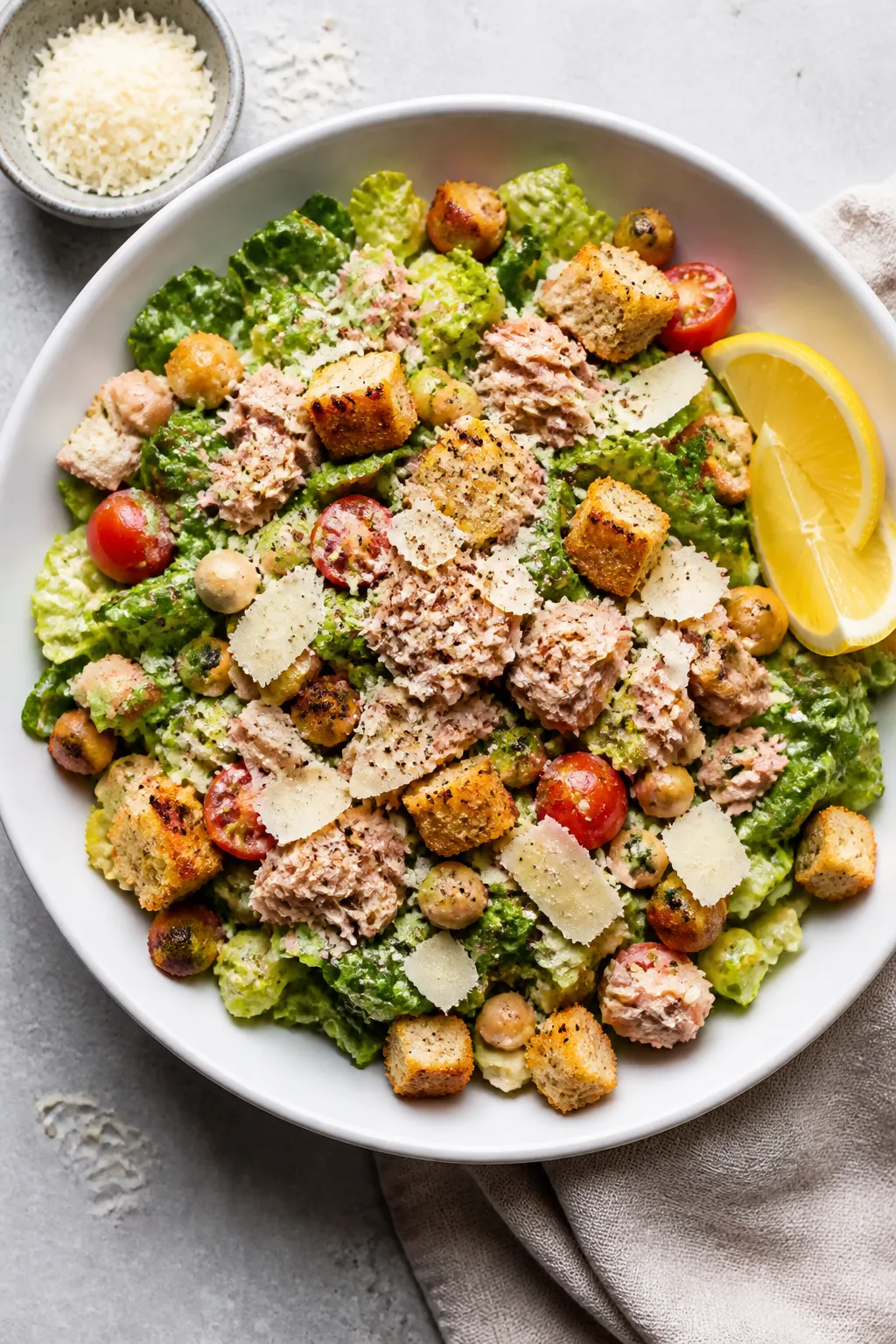 Tasty top view: Overhead shot of the assembled High Protein Tuna Caesar Salad in a wide, shallow whi